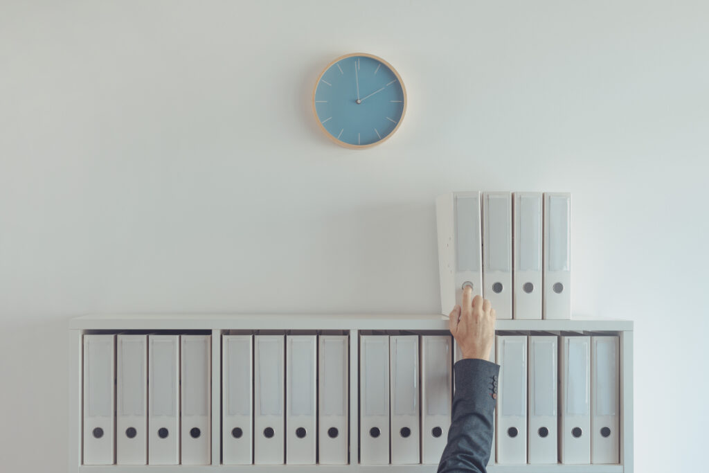 Busy archive administration business person working with ring binders